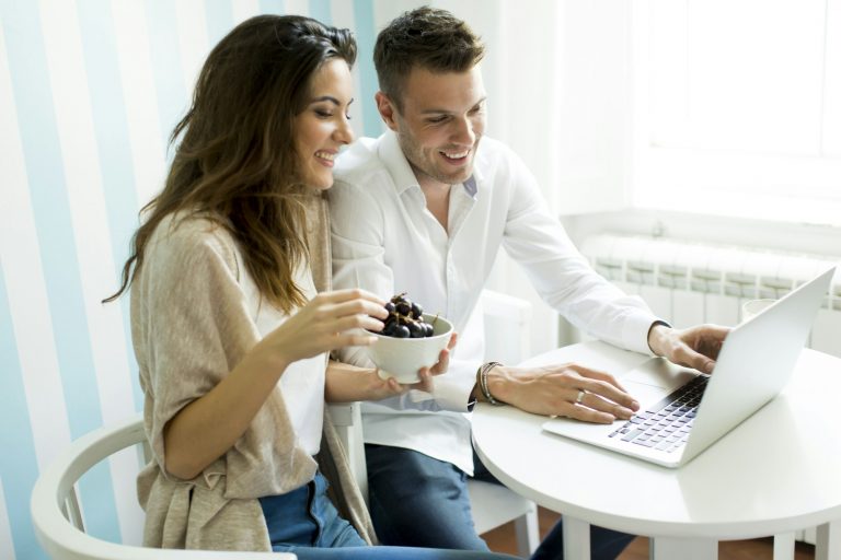 Couple at home websurfing on internet